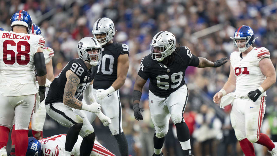 November 5, 2023; Paradise, Nevada, USA; Las Vegas Raiders defensive end Maxx Crosby (98) and defensive tackle Adam Butler (69) celebrate after sacking New York Giants quarterback Tommy DeVito (15) during the third quarter at Allegiant Stadium. Mandatory Credit: Kyle Terada-USA TODAY Sports | Kyle Terada-USA TODAY Sports