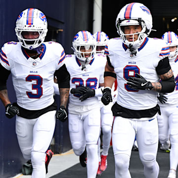 Buffalo Bills safety Damar Hamlin and safety Taylor Rapp run onto the field before a game against the New England Patriots.