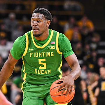 Feb 19, 2025; Iowa City, Iowa, USA; Oregon Ducks guard TJ Bamba (5) controls the ball against the Iowa Hawkeyes during the first half at Carver-Hawkeye Arena. Mandatory Credit: Jeffrey Becker-Imagn Images