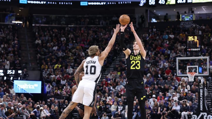 Mar 27, 2024; Salt Lake City, Utah, USA; Utah Jazz forward Lauri Markkanen (23) takes a three point shot over San Antonio Spurs forward Jeremy Sochan (10) during the second quarter at Delta Center. Mandatory Credit: Rob Gray-USA TODAY Sports