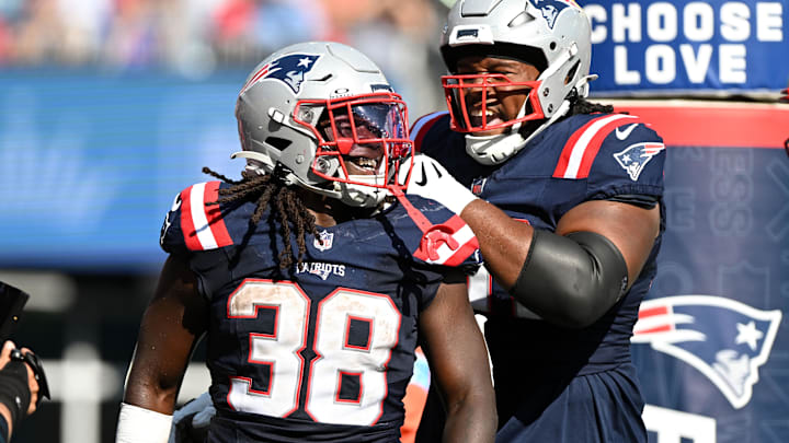 Sep 15, 2024; Foxborough, Massachusetts, USA;  New England Patriots running back Rhamondre Stevenson (38) celebrates with offensive tackle Caedan Wallace (70) after scoring a touchdown against the Seattle Seahawks during the second half at Gillette Stadium. Mandatory Credit: Brian Fluharty-Imagn Images