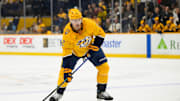 Jan 14, 2025; Nashville, Tennessee, USA;  Nashville Predators defenseman Luke Schenn (2) skates with the puck against the Vegas Golden Knights during the first period at Bridgestone Arena. Mandatory Credit: Steve Roberts-Imagn Images