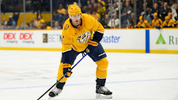Jan 14, 2025; Nashville, Tennessee, USA;  Nashville Predators defenseman Luke Schenn (2) skates with the puck against the Vegas Golden Knights during the first period at Bridgestone Arena. Mandatory Credit: Steve Roberts-Imagn Images