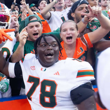 Miami Hurricanes offensive lineman Matthew McCoy (78) celebrates with fans after defeating the Gators during the season opener at Ben Hill Griffin Stadium in Gainesville, FL on Saturday, August 31, 2024 against the University of Miami Hurricanes. The Hurricanes defeated the Gators 41-17. [Doug Engle/Gainesville Sun]