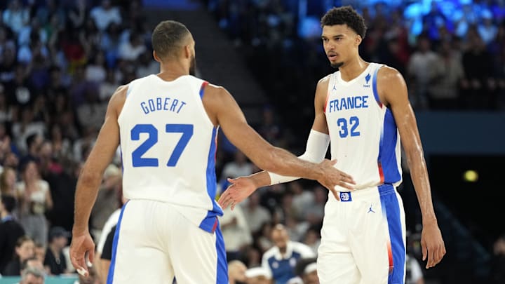 Aug 8, 2024; Paris, France; France center Rudy Gobert (27) and power forward Victor Wembanyama (32) celebrate during the first half against Germany in a men's basketball semifinal game during the Paris 2024 Olympic Summer Games at Accor Arena.