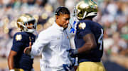 Notre Dame head coach Marcus Freeman, center, slaps hands with running back Jeremiyah Love (4) after a Love touchdown in the first half of a NCAA football game against NC State at Notre Dame Stadium on Saturday, Oct. 11, 2025, in South Bend.