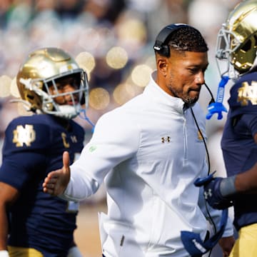 Notre Dame head coach Marcus Freeman, center, slaps hands with running back Jeremiyah Love (4) after a Love touchdown in the first half of a NCAA football game against NC State at Notre Dame Stadium on Saturday, Oct. 11, 2025, in South Bend.