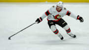 Jan 9, 2025; Ottawa, Ontario, CAN; Ottawa Senators center Nick Cousins (21) reaches for the puck in the third period against the Buffalo Sabres at the Canadian Tire Centre. Mandatory Credit: Marc DesRosiers-Imagn Images