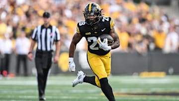 Aug 30, 2025; Iowa City, Iowa, USA; Iowa Hawkeyes running back Kamari Moulton (28) runs the ball against the Albany Great Danes during the first quarter at Kinnick Stadium. Mandatory Credit: Jeffrey Becker-Imagn Images
