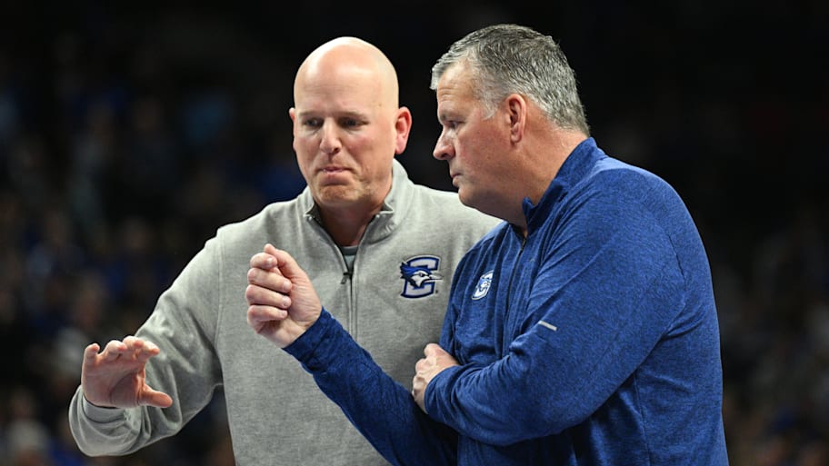 Creighton Bluejays head coach Greg McDermott and assistant coach Alan Huss talk during a break.