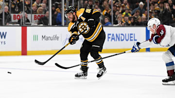Jan 25, 2025; Boston, Massachusetts, USA; Boston Bruins right wing David Pastrnak (88) shoots and scores an empty net goal against the Colorado Avalanche during the third period at the TD Garden. Mandatory Credit: Brian Fluharty-Imagn Images