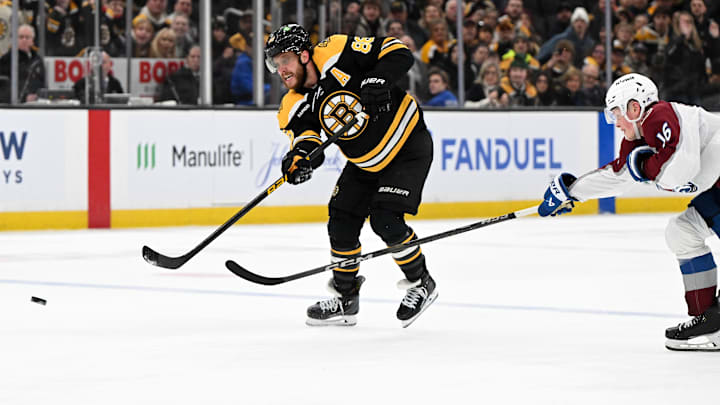Jan 25, 2025; Boston, Massachusetts, USA; Boston Bruins right wing David Pastrnak (88) shoots and scores an empty net goal against the Colorado Avalanche during the third period at the TD Garden. Mandatory Credit: Brian Fluharty-Imagn Images