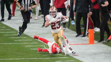 Feb 11, 2024; Paradise, Nevada, USA; San Francisco 49ers running back Christian McCaffrey (23) runs with the ball against Kansas City Chiefs safety Mike Edwards (21) during overtime of Super Bowl LVIII at Allegiant Stadium. Mandatory Credit: Joe Camporeale-USA TODAY Sports