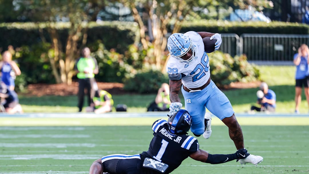 Sep 28, 2024; Durham, North Carolina, USA; Duke Blue Devils safety Terry Moore (1) tackles North Carolina Tar Heels running back Omarion Hampton (28) with the ball during the first half of the game at Wallace Wade Stadium. M Sep 28, 2024; Durham, North Carolina, USA; Duke Blue Devils safety Terry Moore (1) tackles North Carolina Tar Heels running back Omarion Hampton (28) with the ball during the first half of the game at Wallace Wade Stadium. M
