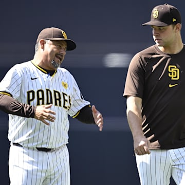 Jun 22, 2024; San Diego, California, USA; San Diego Padres pitching coach Ruben Niebla (left) talks to starting pitcher Michael King (center) and starting pitcher Dylan Cease (right) before the game against the Milwaukee Brewers at Petco Park. Mandatory Credit: Orlando Ramirez-Imagn Images