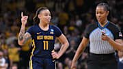 Mar 25, 2024; Iowa City, IA, USA; West Virginia Mountaineers guard JJ Quinerly (11) talks with an official during the fourth quarter against the Iowa Hawkeyes in the NCAA second round game at Carver-Hawkeye Arena. Mandatory Credit: Jeffrey Becker-Imagn Images