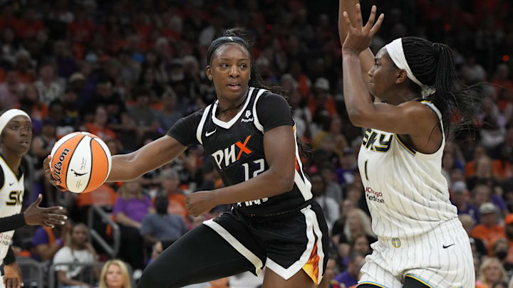 May 21, 2023; Phoenix, Arizona, USA; Phoenix Mercury forward Michaela Onyenwere (12) drives around Chicago Sky center Elizabeth Williams (1) in the first half at Footprint Center. Mandatory Credit: Rick Scuteri-Imagn Images