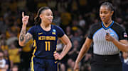 Mar 25, 2024; Iowa City, IA, USA; West Virginia Mountaineers guard JJ Quinerly (11) talks with an official during the fourth quarter against the Iowa Hawkeyes in the NCAA second round game at Carver-Hawkeye Arena. Mandatory Credit: Jeffrey Becker-Imagn Images