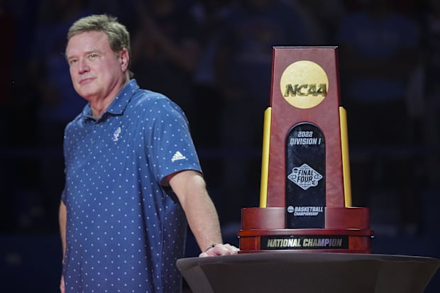 Kansas Jayhawks head coach Bill Self stands next to the 2022 NCAA National Championship Trophy