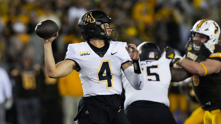 Sep 23, 2023; Laramie, Wyoming, USA; Appalachian State Mountaineers quarterback Joey Aguilar (4) looks to throw  against the Wyoming Cowboys during the third quarter at Jonah Field at War Memorial Stadium. Mandatory Credit: Troy Babbitt-USA TODAY Sports