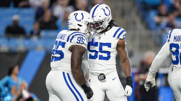 Nov 5, 2023; Charlotte, North Carolina, USA; Indianapolis Colts defensive end Adetomiwa Adebawore (95) and linebacker Isaiah Land (55) react to a sack against Carolina Panthers quarterback Bryce Young (9) during the second half at Bank of America Stadium. Mandatory Credit: Jim Dedmon-USA TODAY Sports