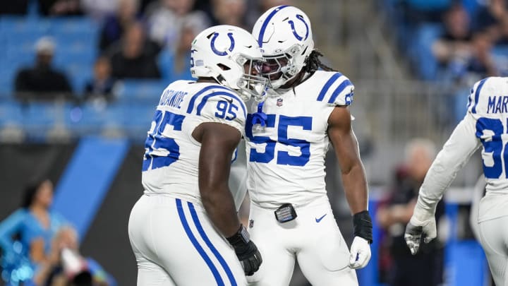 Nov 5, 2023; Charlotte, North Carolina, USA; Indianapolis Colts defensive end Adetomiwa Adebawore (95) and linebacker Isaiah Land (55) react to a sack against Carolina Panthers quarterback Bryce Young (9) during the second half at Bank of America Stadium. Mandatory Credit: Jim Dedmon-USA TODAY Sports