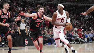 Apr 16, 2025; Chicago, Illinois, USA; Chicago Bulls guard Josh Giddey (3) defends Miami Heat center Bam Adebayo (13) during the second half at United Center. Mandatory Credit: David Banks-Imagn Images