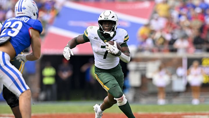 Baylor Bears running back Bryson Washington (7) runs with the ball during the game between the SMU Mustangs and the Baylor Bears at Gerald J. Ford Stadium