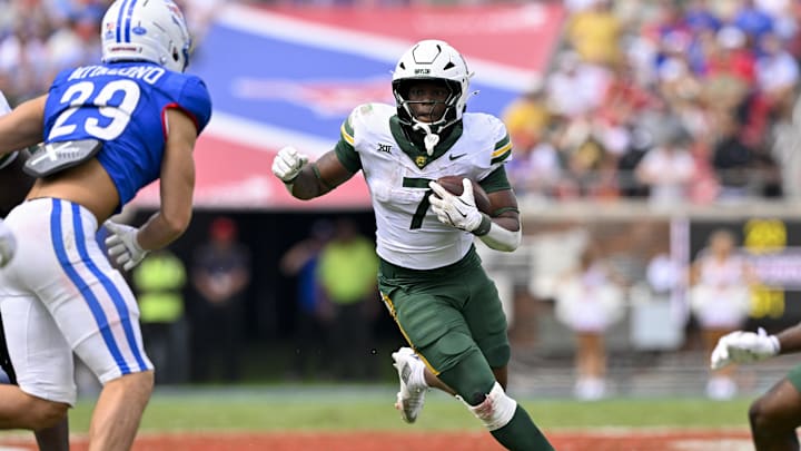 Sep 6, 2025; Dallas, Texas, USA; Baylor Bears running back Bryson Washington (7) runs with the ball during the game between the SMU Mustangs and the Baylor Bears at Gerald J. Ford Stadium. Mandatory Credit: Jerome Miron-Imagn Images