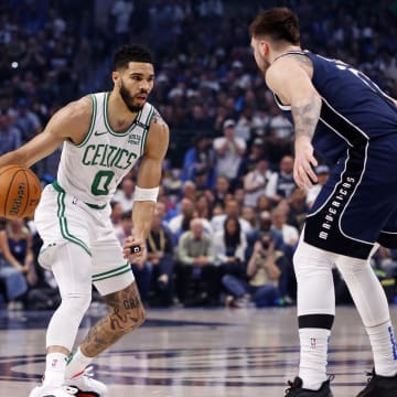 Jun 14, 2024; Dallas, Texas, USA; Boston Celtics forward Jayson Tatum (0) dribbles the ball against Dallas Mavericks guard Luka Doncic (77) during the first quarter during game four of the 2024 NBA Finals at American Airlines Center. Mandatory Credit: Peter Casey-USA TODAY Sports