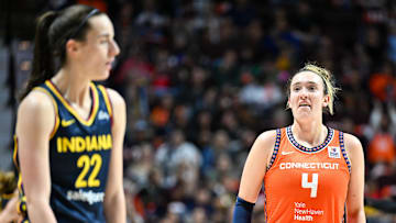 Sep 22, 2024; Uncasville, Connecticut, USA; Connecticut Sun guard Marina Mabrey (4) stares at Indiana Fever guard Caitlin Clark (22) in the third quarter during game one of the first round of the 2024 WNBA Playoffs at Mohegan Sun Arena. 