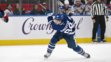 Oct 16, 2025; Toronto, Ontario, CAN; Toronto Maple Leafs forward Nick Robertson (89) follows through on a slapshot against the New York Rangers in the third period at Scotiabank Arena. Mandatory Credit: Dan Hamilton-Imagn Images