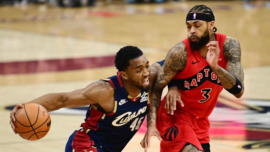 Cleveland Cavaliers guard Donovan Mitchell drives to the basket against Toronto Raptors forward Brandon Ingram.