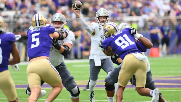 UW edge rushers Zach Durfee (5), who had 2.5 sacks, and Isaiah Ward (91), put pressure on Eastern Michigan QB Cole Snyder.