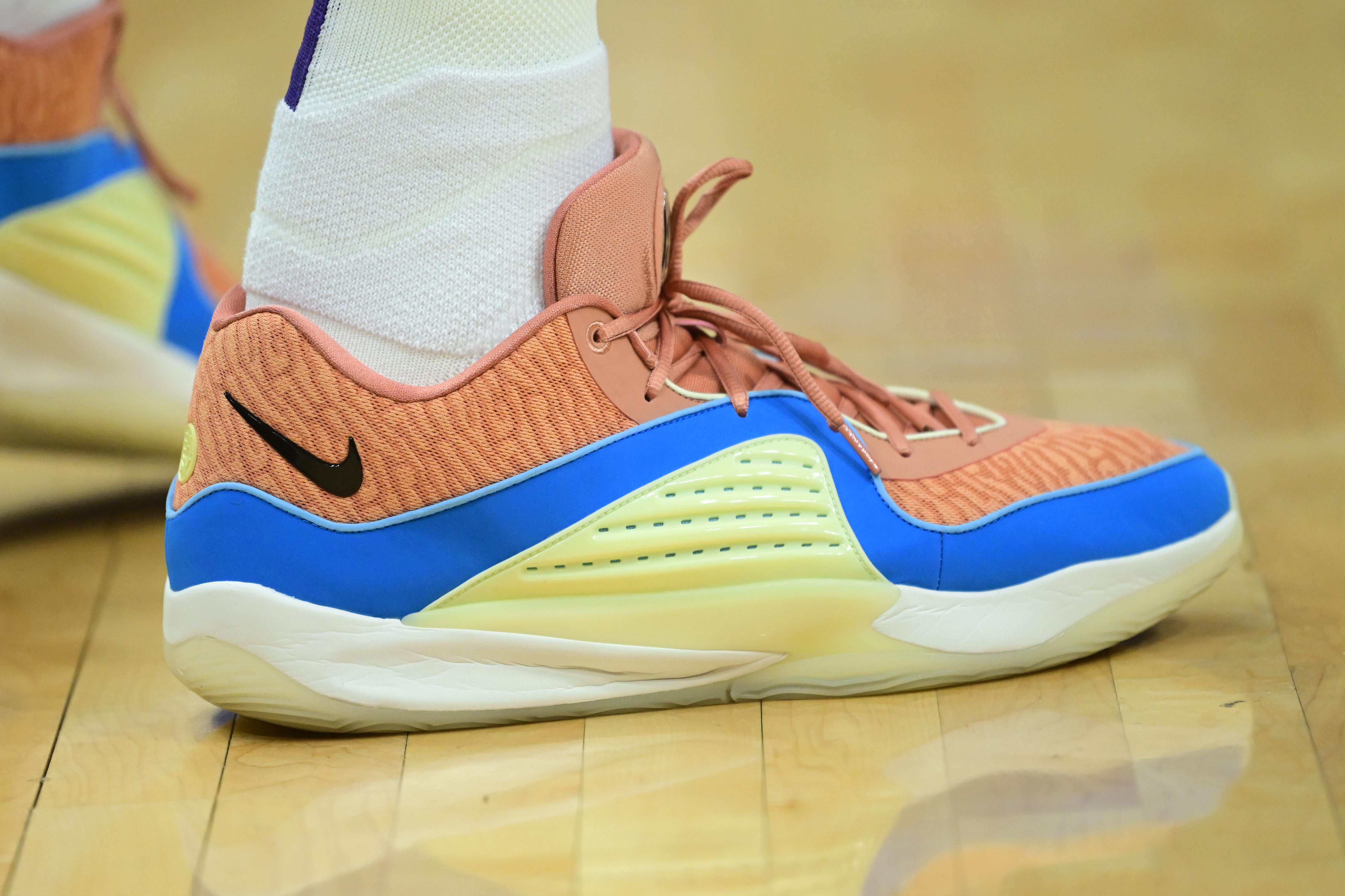 Phoenix Suns forward Kevin Durant's orange and blue Nike sneakers.