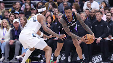 Feb 28, 2025; Salt Lake City, Utah, USA; Utah Jazz forward John Collins (20) holds the ball away from Minnesota Timberwolves guard Nickeil Alexander-Walker (9) during the second quarter at Delta Center. Mandatory Credit: Rob Gray-Imagn Images