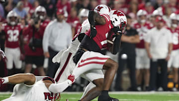 Aug 28, 2025; Madison, Wisconsin, USA;  Miami (OH) RedHawks linebacker Oscar McWood (23) tries to tackle Wisconsin Badgers running back Dilin Jones (7) during the third quarter at Camp Randall Stadium. Mandatory Credit: Jeff Hanisch-Imagn Images