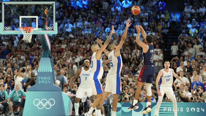 Aug 10, 2024; Paris, France; United States shooting guard Stephen Curry (4) shoots against France small forward Nicolas Batum (5) and shooting guard Evan Fournier (10) in the second half against France in the men's basketball gold medal game during the Paris 2024 Olympic Summer Games at Accor Arena. Mandatory Credit: Kyle Terada-USA TODAY Sports