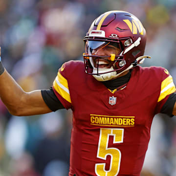 Washington Commanders quarterback Jayden Daniels (5) celebrates after throwing a touchdown during the fourth quarter against the Philadelphia Eagles at Northwest Stadium. Mandatory Credit: Peter Casey-Imagn Images