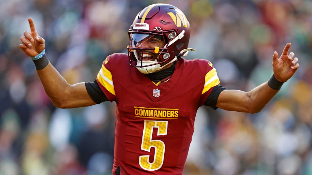 Dec 22, 2024; Landover, Maryland, USA; Washington Commanders quarterback Jayden Daniels (5) celebrates after throwing a touchdown during the fourth quarter against the Philadelphia Eagles at Northwest Stadium. Mandatory Credit: Peter Casey-Imagn Images