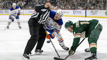 Jan 15, 2025; Saint Paul, Minnesota, USA;  Minnesota Wild forward Joel Eriksson Ek (14) beats Edmonton Oilers forward Connor McDavid (97) on a face-off during the second period at Xcel Energy Center. Mandatory Credit: Nick Wosika-Imagn Images

