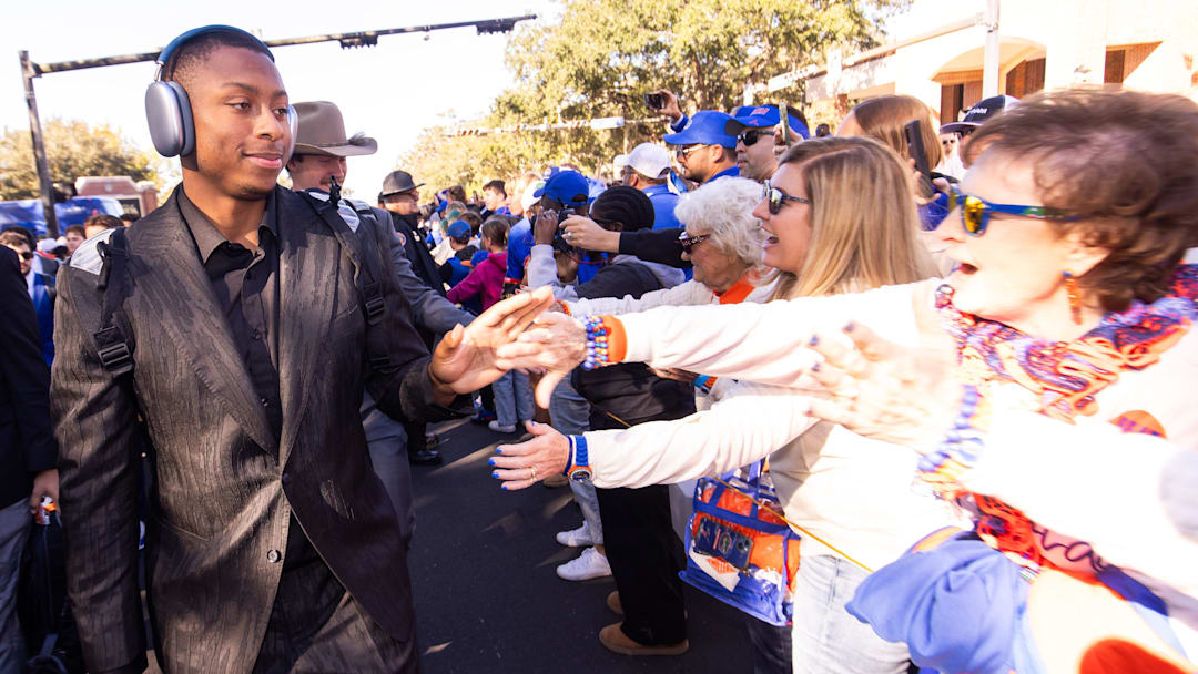 Florida Gators quarterback DJ Lagway (2) gives high-fives with fans during Gator Walk at Ben Hill Griffin Stadium in Gainesville, FL on Saturday, November 23, 2024 before the game against the University of Mississippi. [Doug Engle/Gainesville Sun]