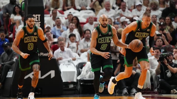 Apr 27, 2024; Miami, Florida, USA; Boston Celtics guard Derrick White (9) brings the ball up the court against the Miami Heat - Jim Rassol/USA TODAY Sports