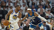May 14, 2025; Minneapolis, Minnesota, USA; Golden State Warriors forward Jonathan Kuminga (00) looks to pass the ball as Minnesota Timberwolves forward Jaden McDaniels (3) plays defense in the first half during game five of the second round for the 2025 NBA Playoffs at Target Center. Mandatory Credit: Jesse Johnson-Imagn Images