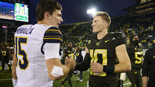 oregon ducks dante moore heisman trophy big ten college football quarterback dan lanning indiana hoosiers fernando mendoza