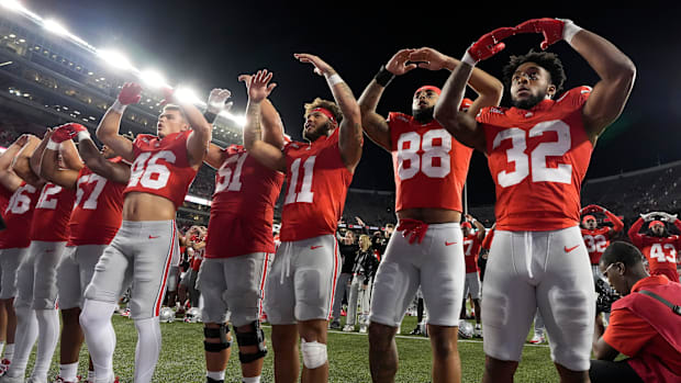 Ohio State Buckeyes running back TreVeyon Henderson (32) sings “Carmen Ohio” with teammates following a 56-0 win over Western