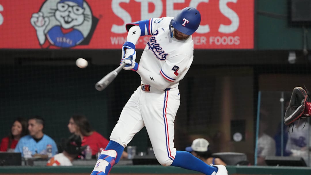 Apr 3, 2026; Arlington, Texas, USA; Texas Rangers right fielder Brandon Nimmo (24) connects for a triple against the Cincinnati Reds during the seventh inning at Globe Life Field. Mandatory Credit: Jim Cowsert-Imagn Images