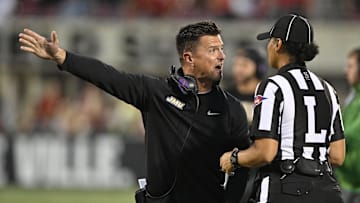 Sep 5, 2025; Louisville, Kentucky, USA;  James Madison Dukes head coach Bob Chesney argues a call with an official during the first half against the Louisville Cardinals at L&N Federal Credit Union Stadium. Mandatory Credit: Jamie Rhodes-Imagn Images