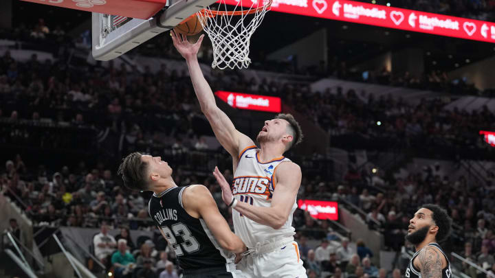 Mar 23, 2024; San Antonio, Texas, USA;  Phoenix Suns forward Drew Eubanks (14) shoots in front of San Antonio Spurs forward Zach Collins (23) in the second half at Frost Bank Center. Mandatory Credit: Daniel Dunn-USA TODAY Sports