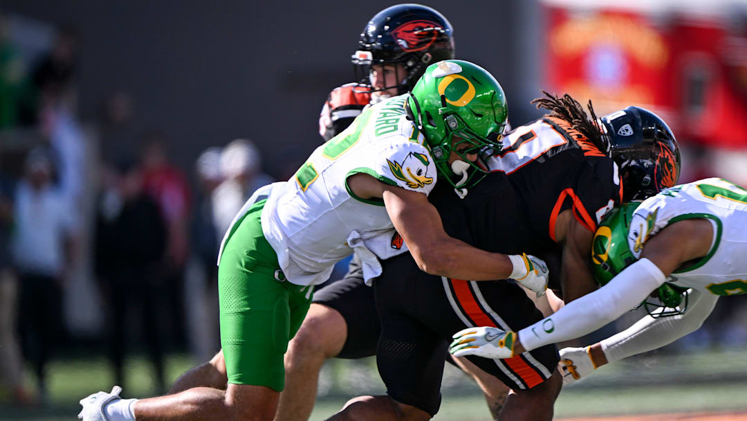 Oregon Ducks defense takes down Oregon State Beavers running back Anthony Hankerson (0) in the second half of the annual rivalry game on Saturday, Sept. 14, 2024 at Reser Stadium in Corvallis, Ore.